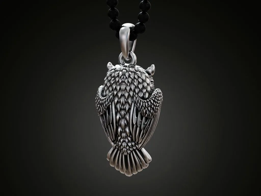 Silver pendant of an owl, intricately designed to showcase its detailed feathers and wise expression.