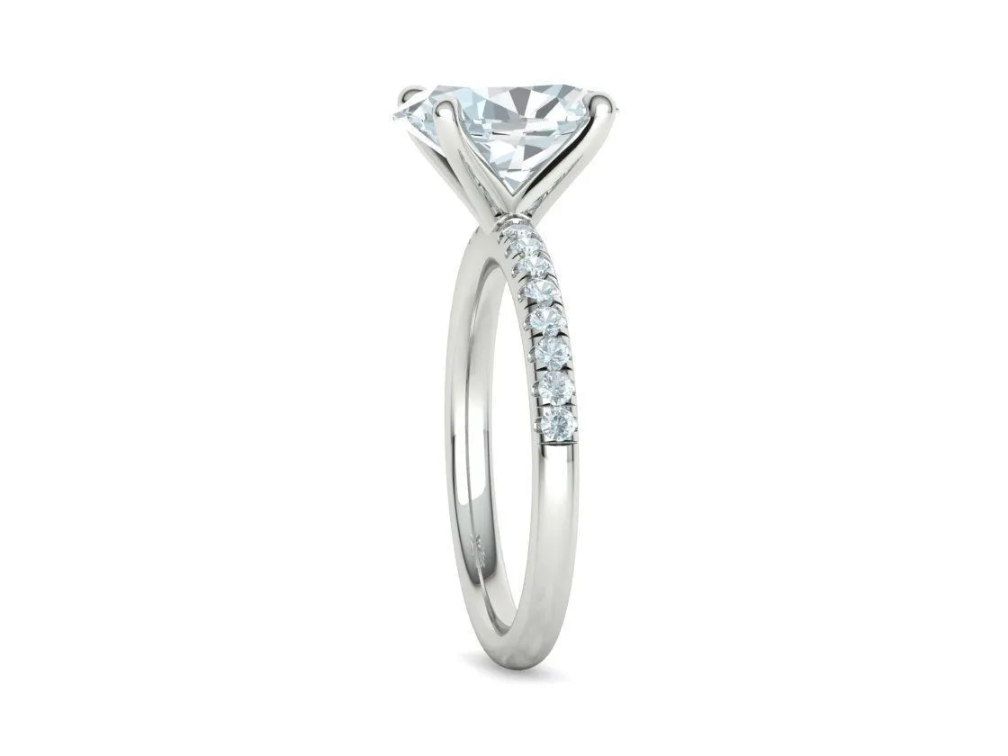 High-polished Oval Pavé Solitaire Ring with a brilliant oval solitaire diamond and pavé-set band, symbolizing luxury and elegance, perfect for any occasion.