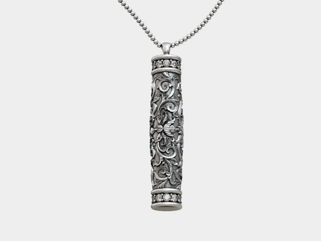 Silver tube pendant with Baroque floral patterns, showcasing intricate and historical art in jewelry design.