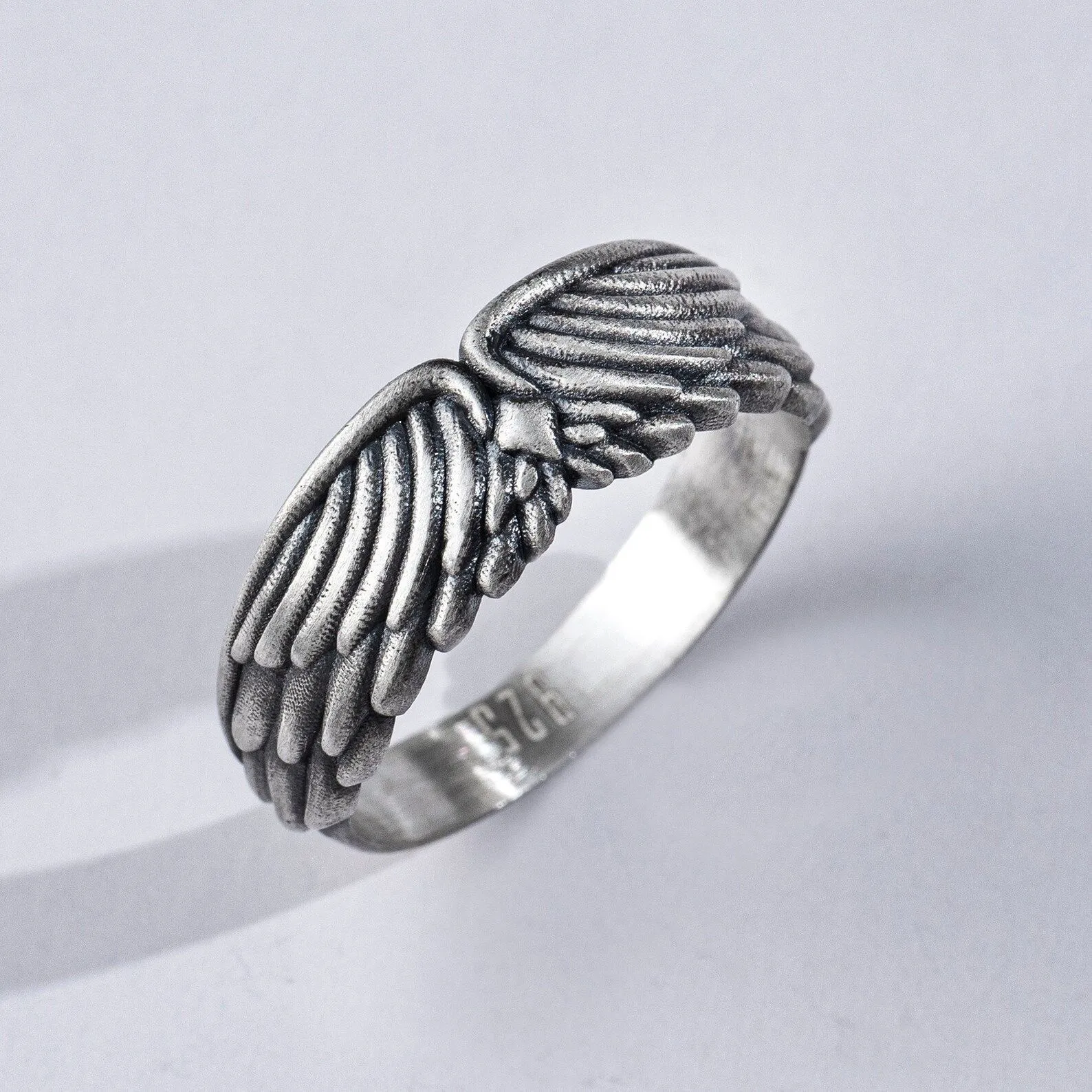 Silver biker ring featuring a detailed depiction of wings and plumage, symbolizing freedom and strength, perfect for men and women who embrace a bold style.