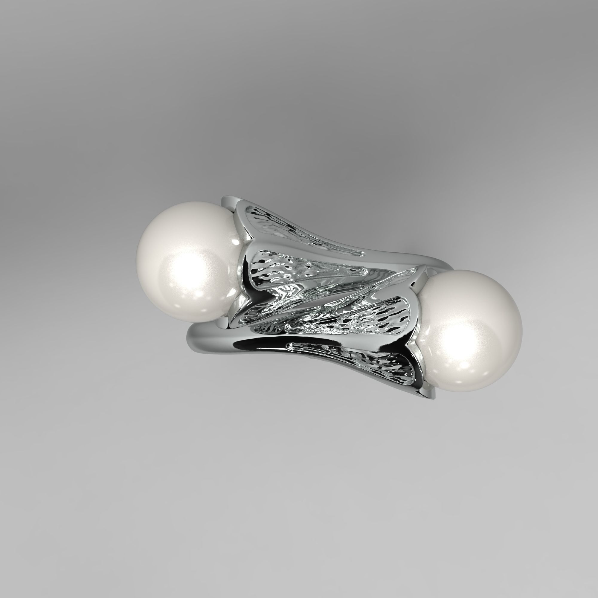 A sophisticated silver ring with two cross-set pearls and intricate detailing.