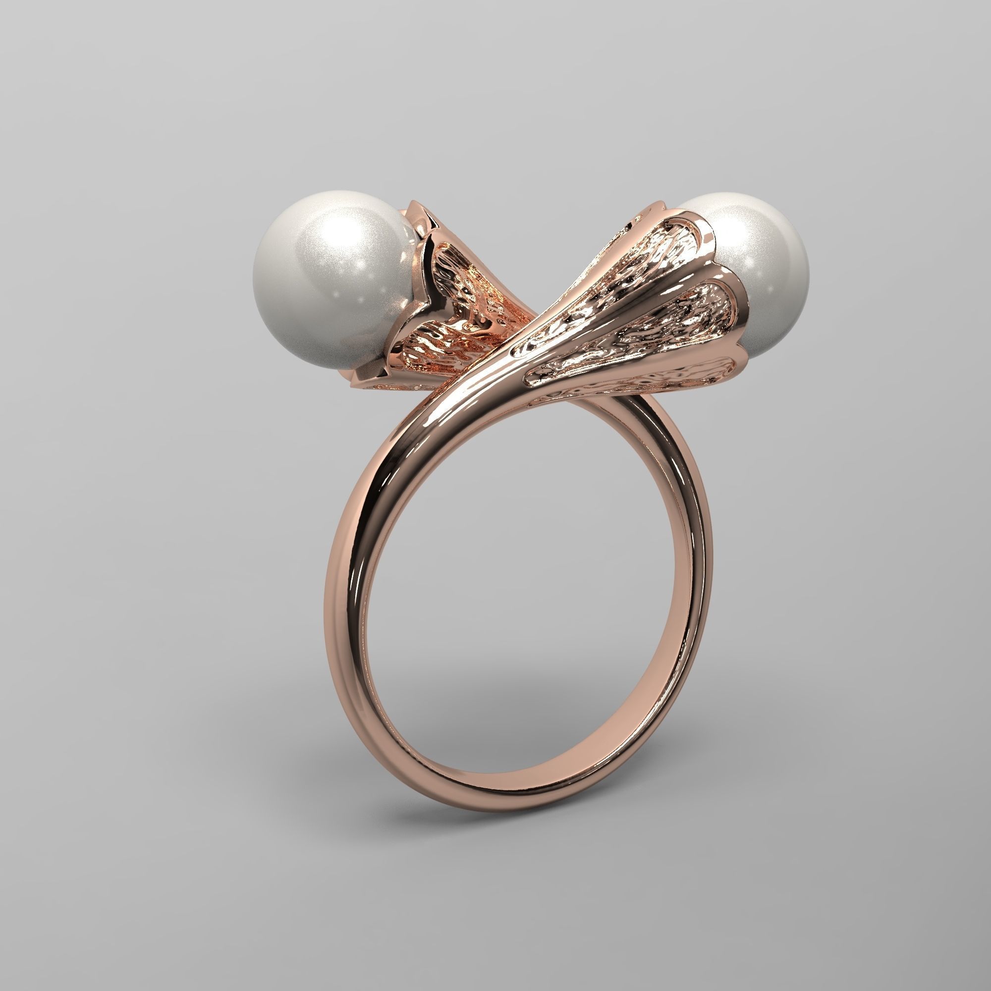 A sophisticated silver ring with two cross-set pearls and intricate detailing.