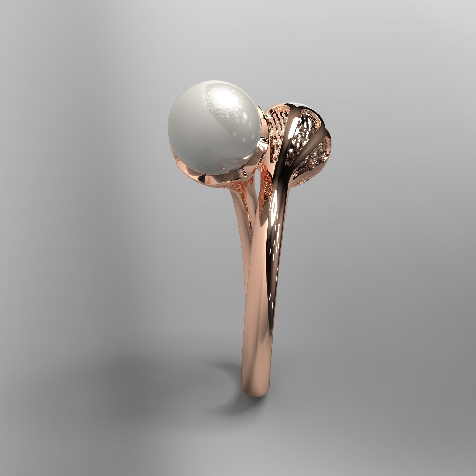 A sophisticated silver ring with two cross-set pearls and intricate detailing.