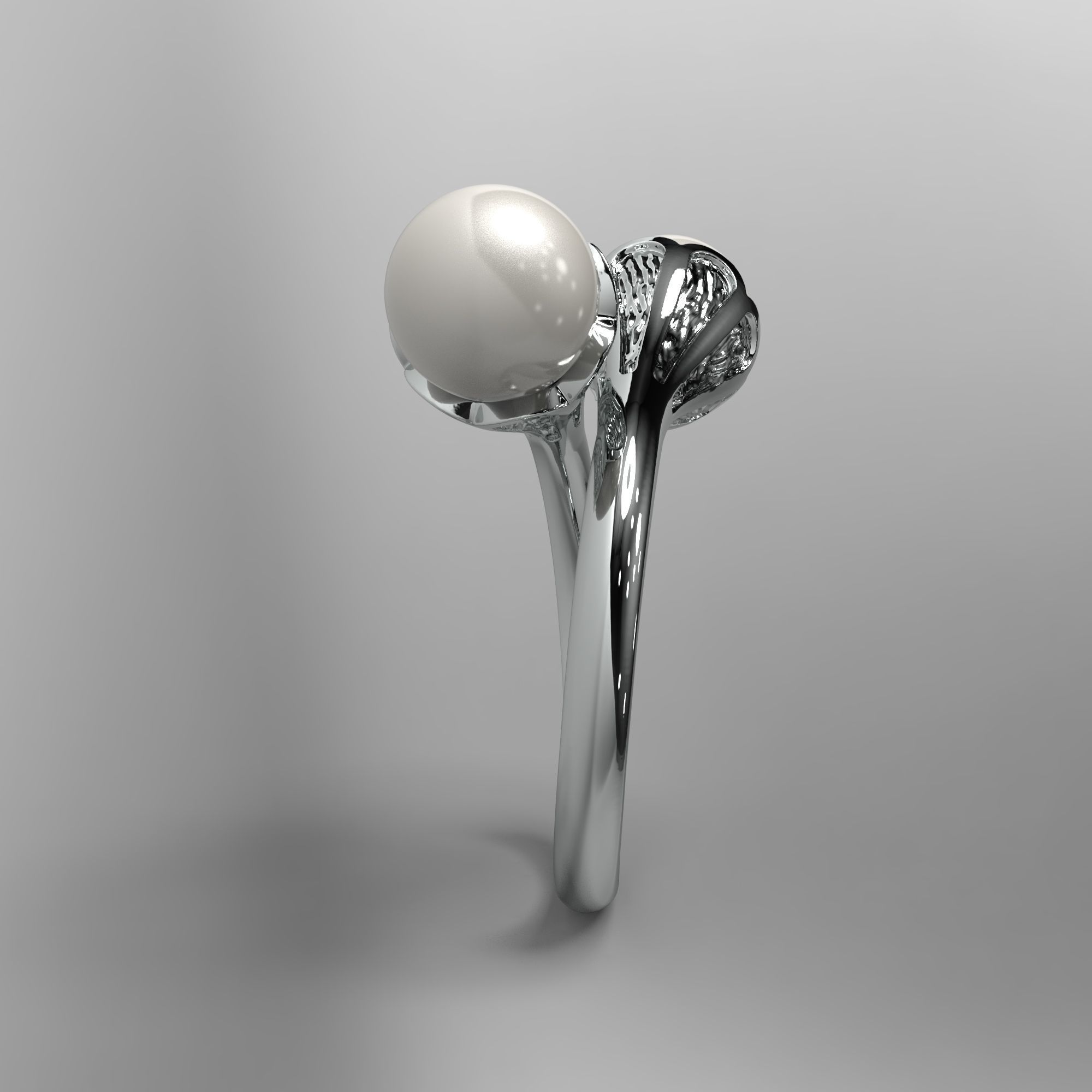 A sophisticated silver ring with two cross-set pearls and intricate detailing.