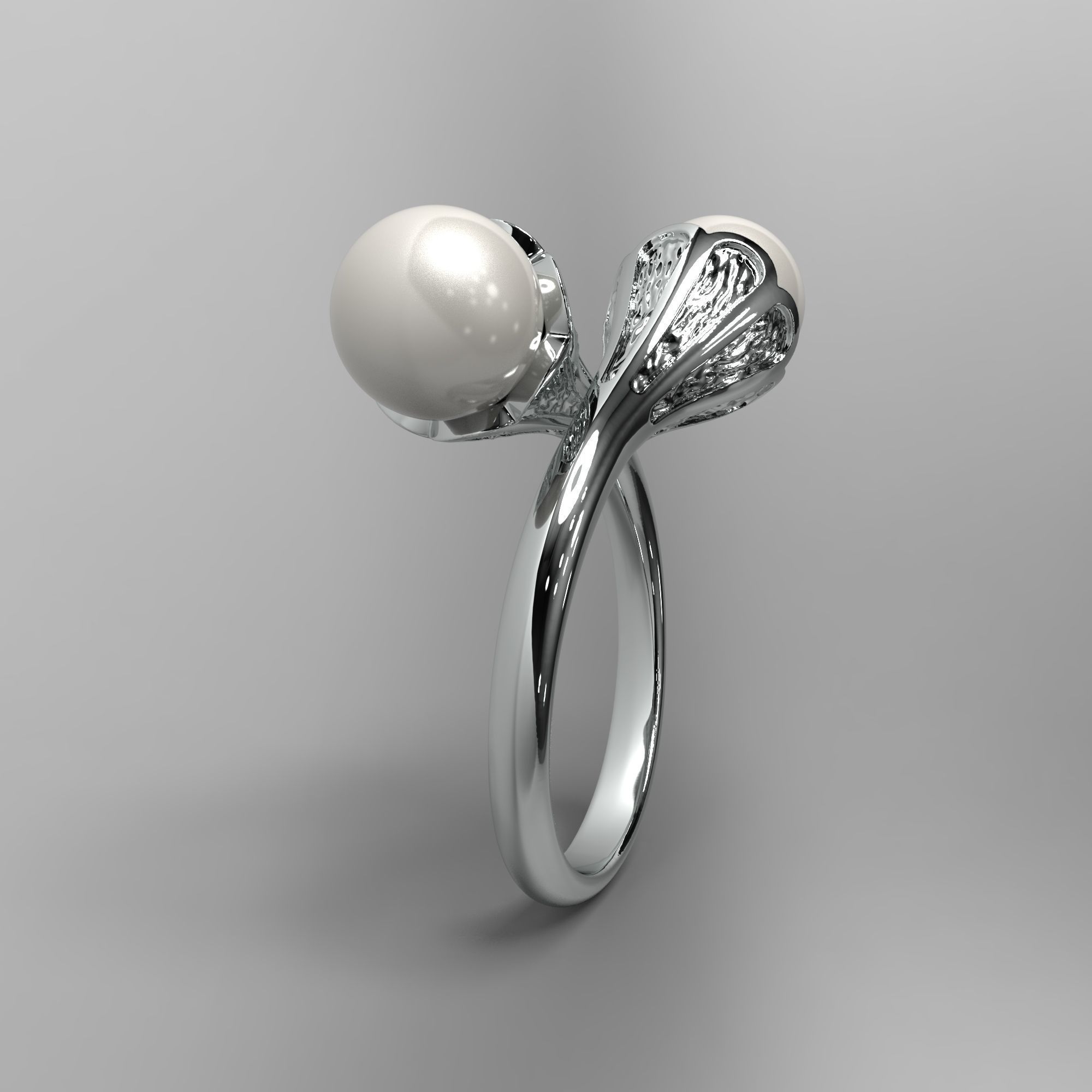 A sophisticated silver ring with two cross-set pearls and intricate detailing.