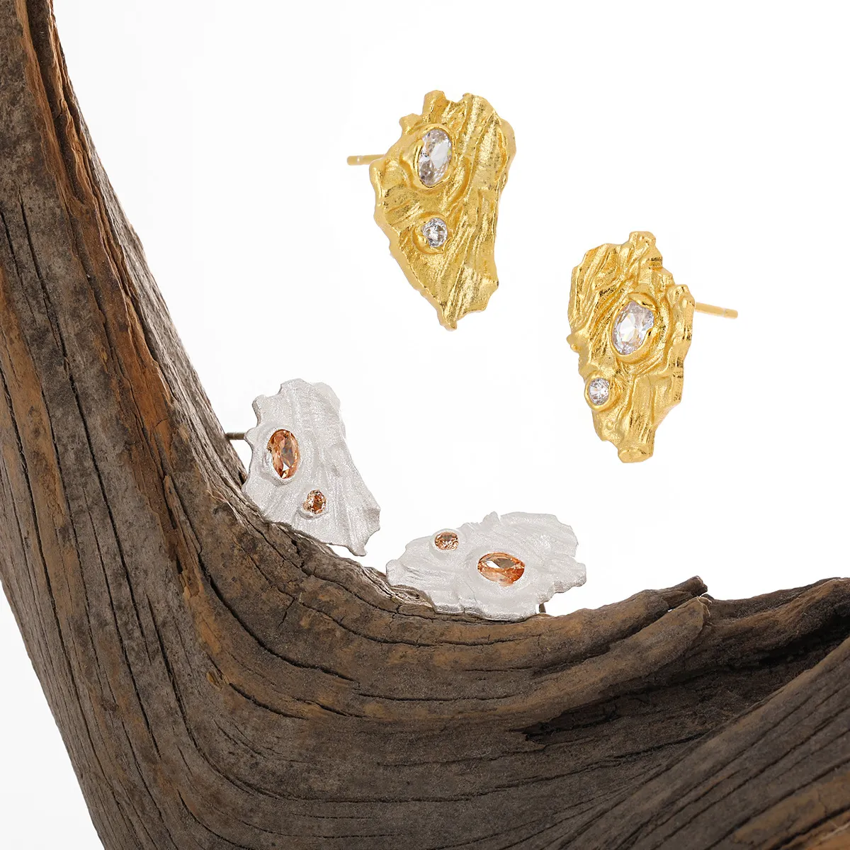 Crystalline textured stud earrings in gold and silver with sparkling crystals.