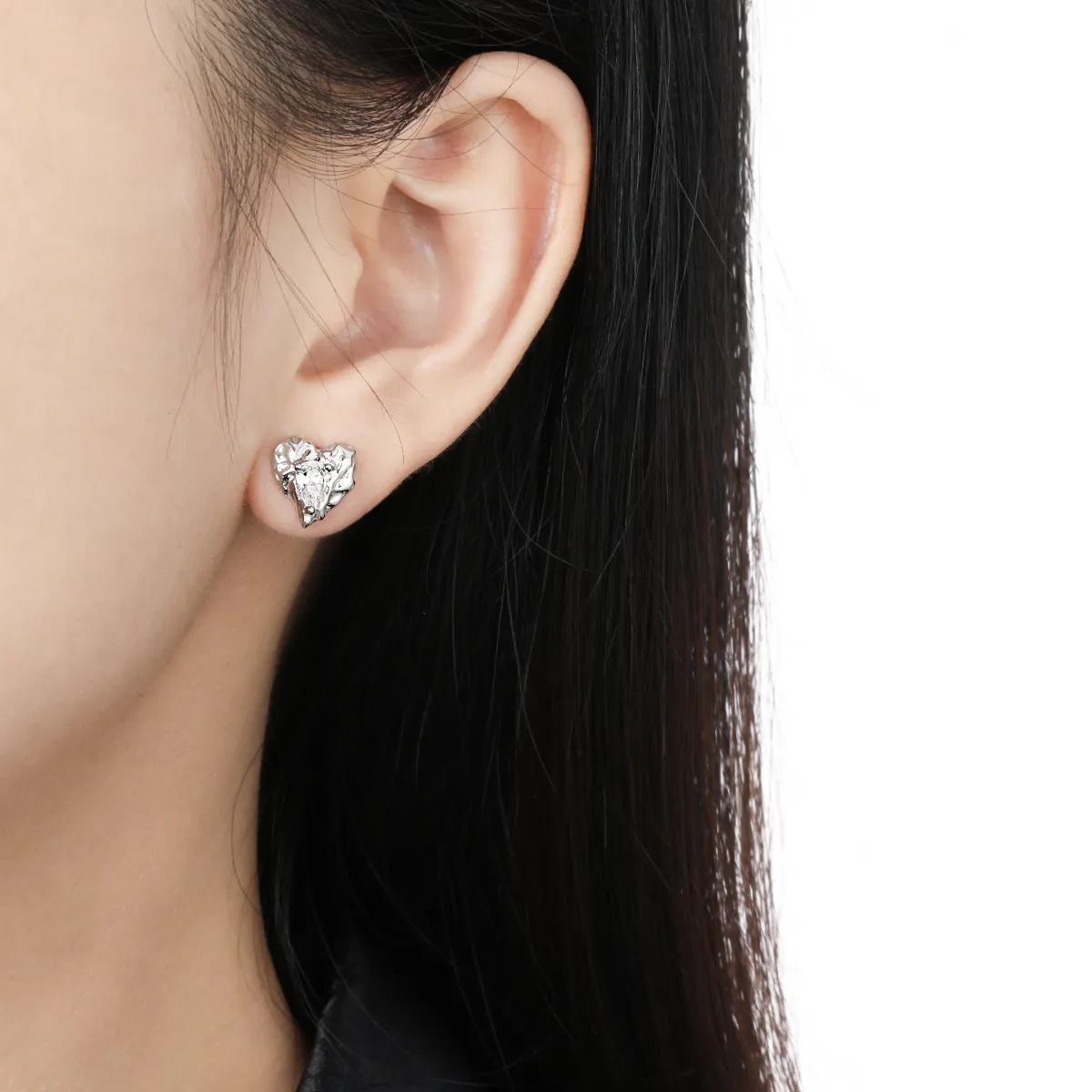 Heart-shaped silver stud earrings with sparkling zircon stones.