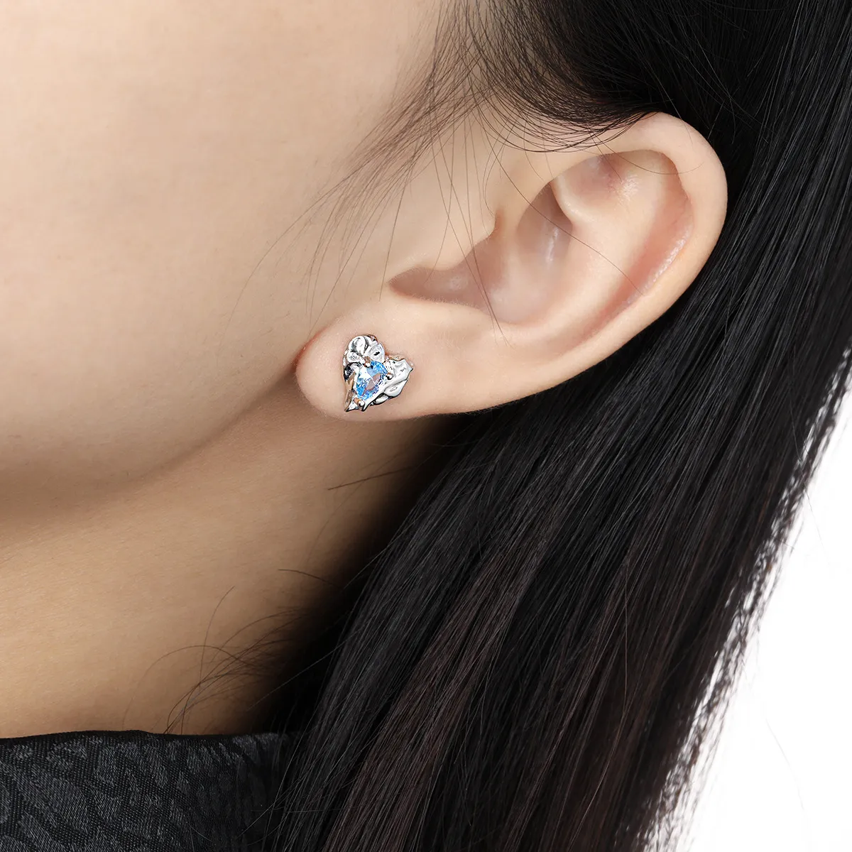 Heart-shaped silver stud earrings with sparkling zircon stones.